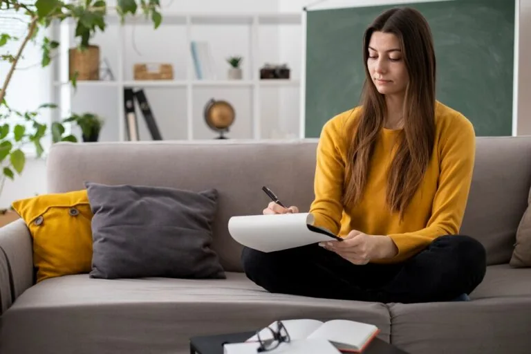 A writer planning a manuscript in a notebook